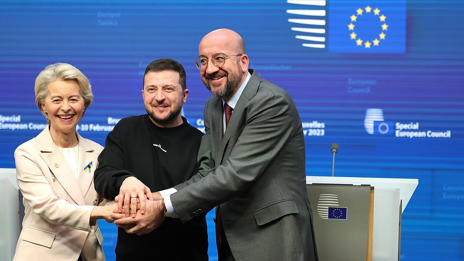 Ursula von der Leyen, Volodymyr Zelenskyy, and Charles Michel join hands after addressing a media conference at an EU summit in Brussels on Thursday, Feb. 9, 2023.