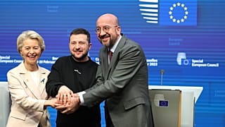 Ursula von der Leyen, Volodymyr Zelenskyy, and Charles Michel join hands after addressing a media conference at an EU summit in Brussels on Thursday, Feb. 9, 2023.