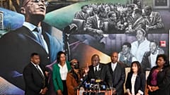 Attorney Ben Crump, center, speaks during a news conference at the Malcolm X & Dr. Betty Shabazz Memorial and Educational Center in New York, Tuesday, Feb. 21, 2023. 