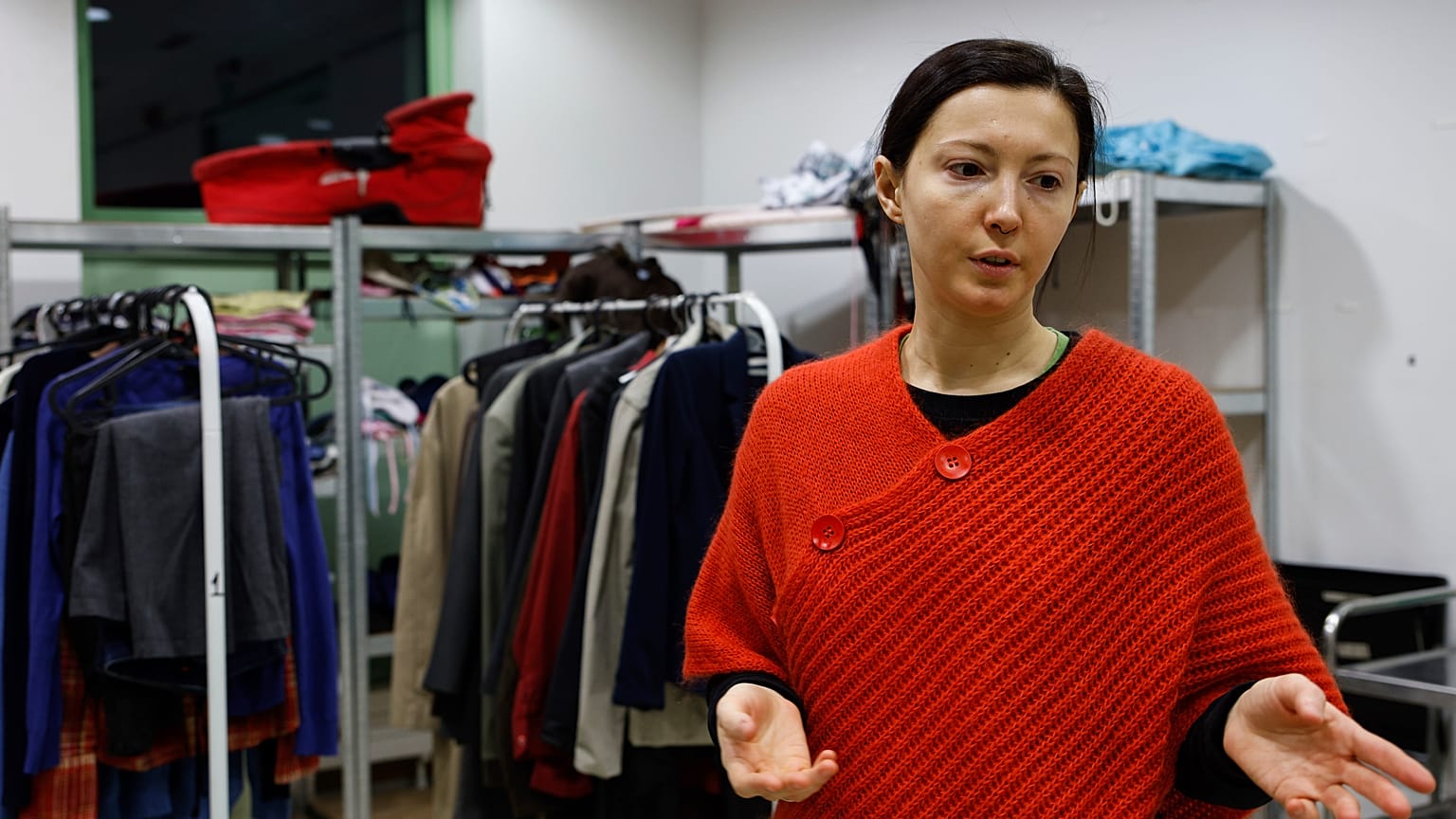 Anastasia Lasna, a Ukrainian refugee from Mykolaiv, gestures as she talks inside a distribution center at the Jewish Community Center in Krakow, Poland.
