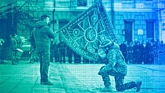 Ukrainian President Volodymyr Zelenskyy holds the flag of a military unit as an officer kisses it in Kyiv, 24 February 2023