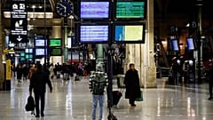 Travellers walks at Gare du Nord train station in Paris on a new day of nationwide strikes and protests against the government's pension reform plan on March 23.