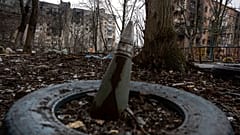 A part of a rocket sticks from a ground in front of a residential building which was heavily bombed by Russian forces in the frontline city of Vuhledar, Ukraine, Saturday, Feb