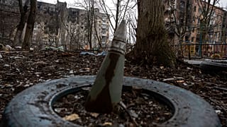 A part of a rocket sticks from a ground in front of a residential building which was heavily bombed by Russian forces in the frontline city of Vuhledar, Ukraine, Saturday, Feb