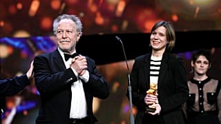 Nicolas Philibert, left, director of the documentary "Sur lAdamant" ("On the Adamant"), receives the Golden Bear for Best Film