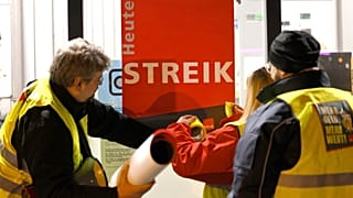 Strikers put a poster with the words 'Strike today' on a window pane in Cologne, Germany, 26 February 2023.