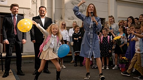 Ukrainian teacher Anastasiia Konovalova dances along with Ukrainian refugee children at the Ienachita Vacarescu Elementary School in Bucharest, Romania, September 5, 2022.