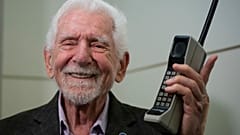 Marty Cooper, the inventor of first commercial mobile phone, poses for the press with a Motorola DynaTAC 8000x
