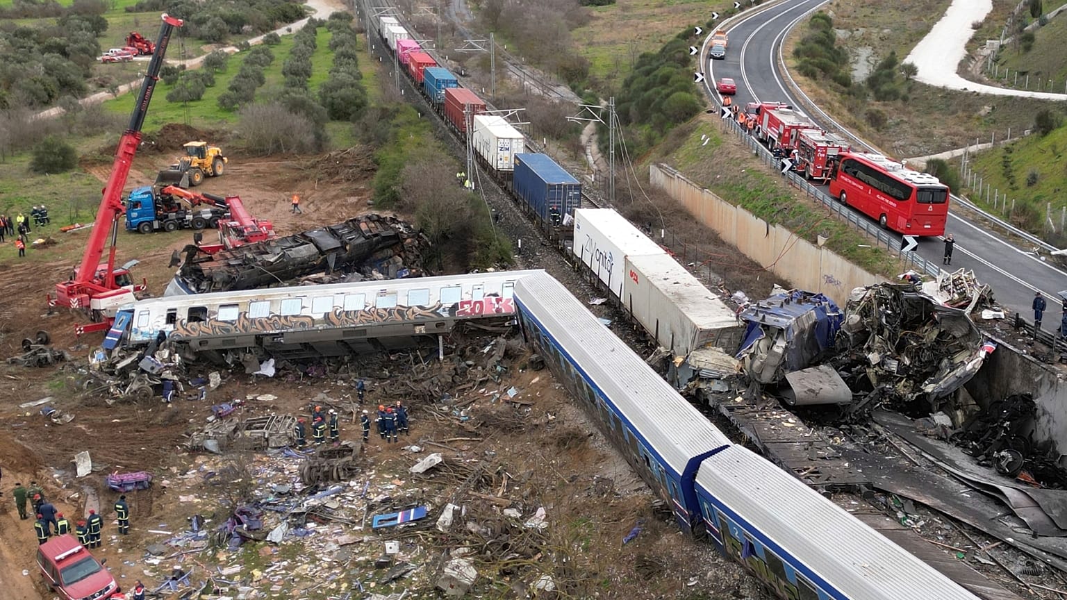 A crane, firefighters and rescuers operate after a collision in Tempe near Larissa city, Greece, Wednesday, March 1, 2023.