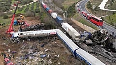 A crane, firefighters and rescuers operate after a collision in Tempe near Larissa city, Greece, Wednesday, March 1, 2023.