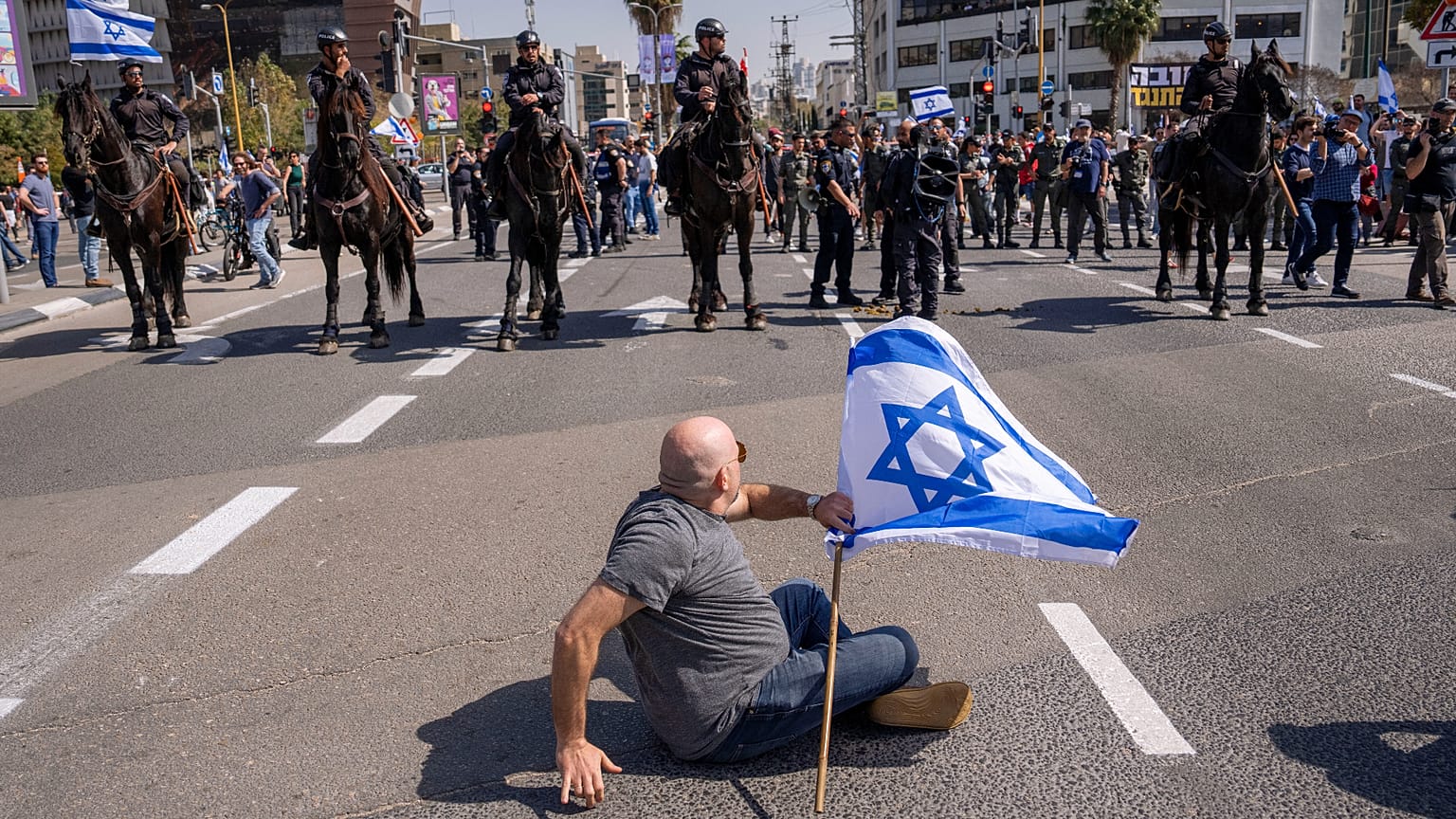 Mounted police are deployed as Israelis block a main road to protest against plans by Prime Minister Benjamin Netanyahu's new government to overhaul the judicial system.