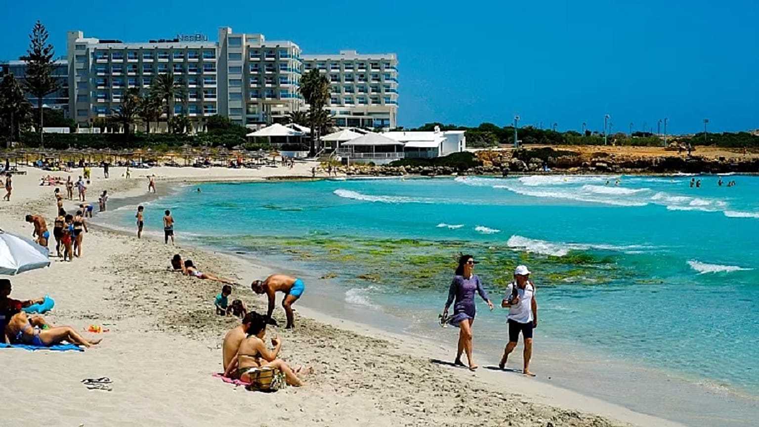 Tourists enjoy the popular Nissi Beach in southeast resort of Ayia Napa.   -  