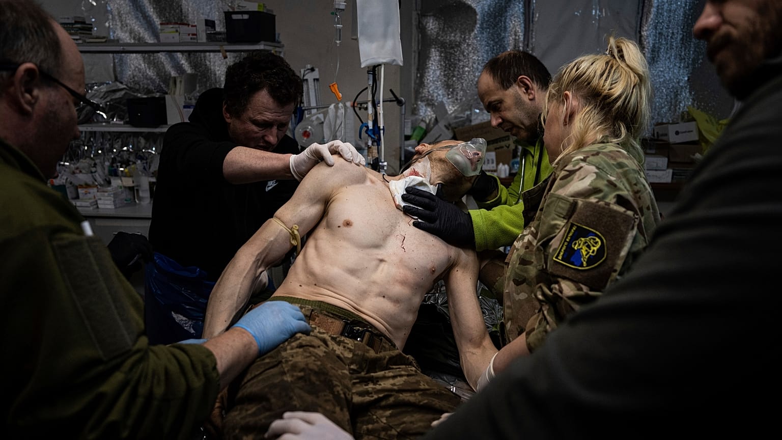 Ukrainian military medics treat their wounded comrade at the field hospital near Bakhmut, Ukraine, Sunday, Feb. 26, 2023. 