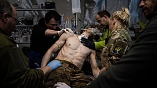 Ukrainian military medics treat their wounded comrade at the field hospital near Bakhmut, Ukraine, Sunday, Feb. 26, 2023. 
