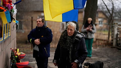 Anna Levchenko reacts during a gathering to mark the first anniversary of the death of eight men killed by Russian forces in Bucha.