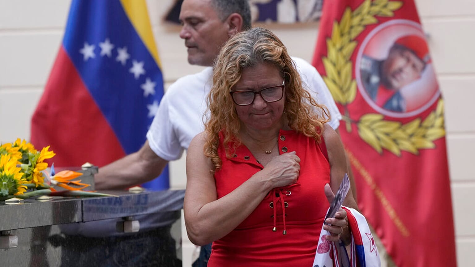 Visitors pay their respects on the tomb of late Venezuelan President Hugo Chavez.