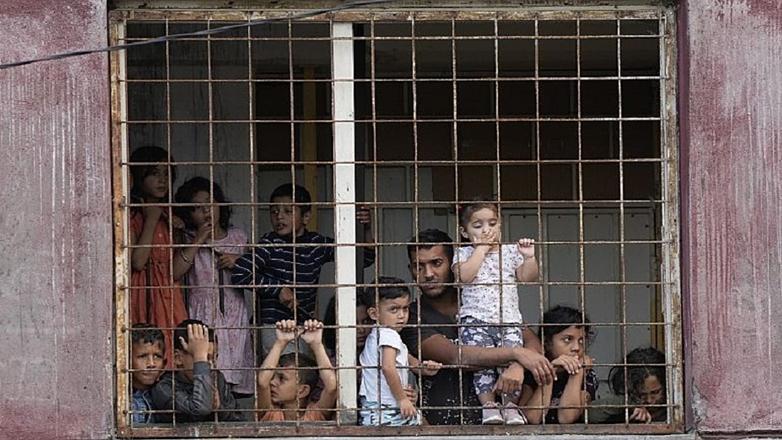 Residents watch Pope Francis meeting with members of the Roma community at Lunik IX, in Kosice, Slovakia, Sept. 14, 2021.   -