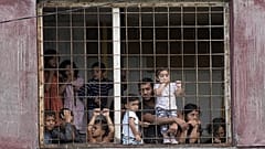 Residents watch Pope Francis meeting with members of the Roma community at Lunik IX, in Kosice, Slovakia, Sept. 14, 2021.   -