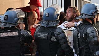 FILE: Police stand in front of fans prior to the UEFA Champions League final in Paris, 28 May 2022