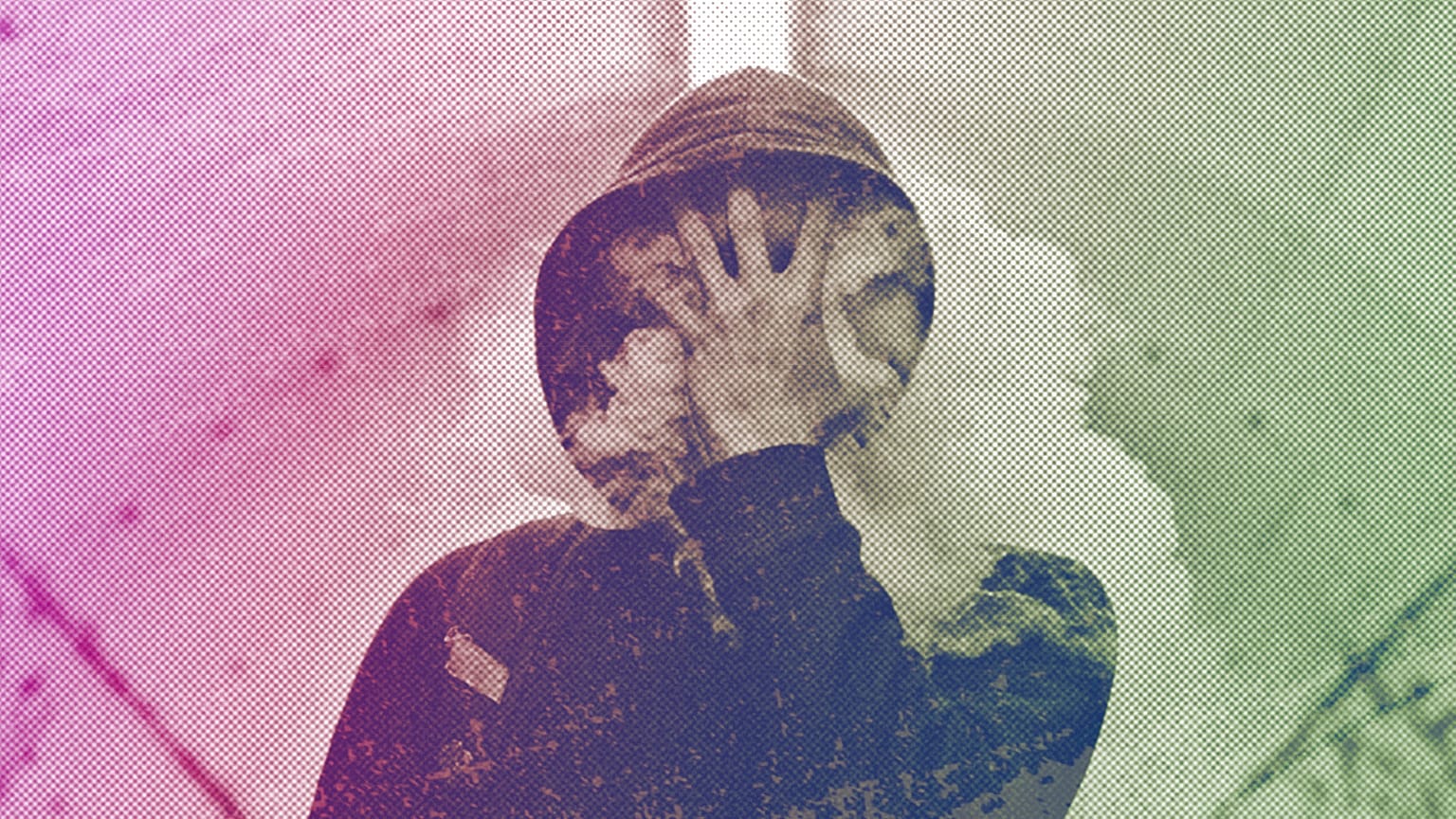 A person covers their face surrounded by a cloud of smoke in Lima, Peru, June 2018