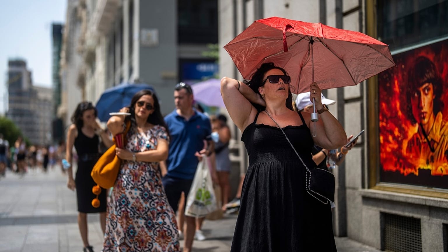 A woman shelters from the sun during a hot sunny day in Madrid, Spain, 18 July 18 2022.
