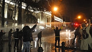 The police fire water cannon at protesters outside the Georgian parliament building in Tbilisi, Georgia, Tuesday, March 7, 2023.