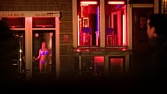 FILE: Sex workers are seen in the Red Light district of Amsterdam, Netherlands, Sunday, Dec. 7, 2008. 