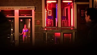 FILE: Sex workers are seen in the Red Light district of Amsterdam, Netherlands, Sunday, Dec. 7, 2008. 