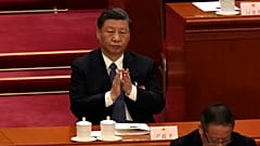 Chinese President Xi Jinping applauds during a session of China's National People's Congress (NPC) at the Great Hall of the People in Beijing, Sunday, March 12, 2023.
