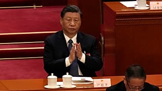 Chinese President Xi Jinping applauds during a session of China's National People's Congress (NPC) at the Great Hall of the People in Beijing, Sunday, March 12, 2023.