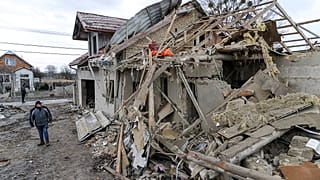 Villagers clear the rubble after Russia's night rocket attack ruined private houses in the Lviv region, Ukraine. March 9, 2023 