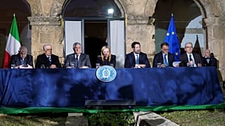 Italian Premier Giorgia Meloni, center, presides over a Cabinet session in Cutro's town council hall, southern Italy, Thursday, March 9, 2023. 