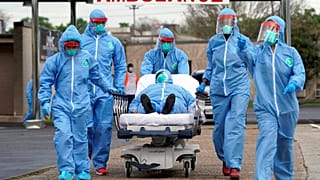 A person is taken on a stretcher into the United Memorial Medical Center after going through testing for COVID-19 Thursday, March 19, 2020, in Houston