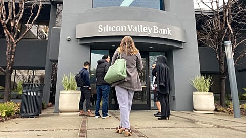 People stand outside of an entrance to Silicon Valley Bank in Santa Clara, California, 10 March 2023