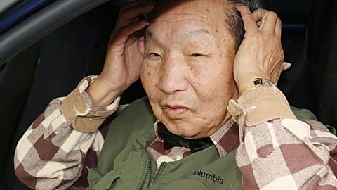 Iwao Hakamada answers to reporters' questions after a walk in Hamamatsu, Shizuoka prefecture, central Japan Monday, March 13, 2023.