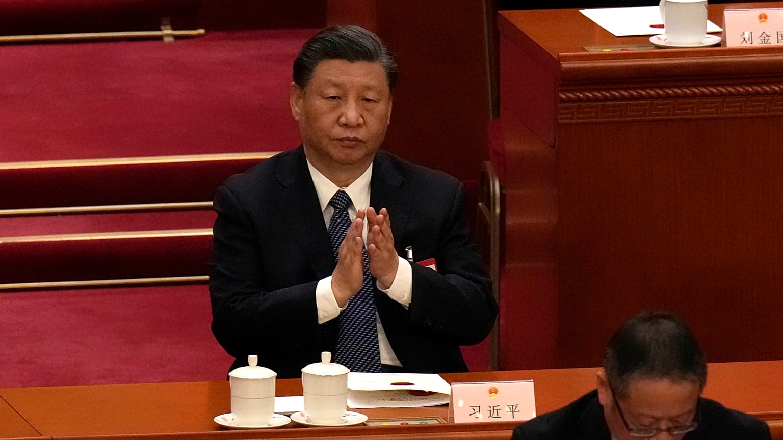 Chinese President Xi Jinping applauds during a session of China's National People's Congress (NPC) at the Great Hall of the People in Beijing, Sunday, March 12, 2023. 