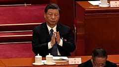 Chinese President Xi Jinping applauds during a session of China's National People's Congress (NPC) at the Great Hall of the People in Beijing, Sunday, March 12, 2023. 