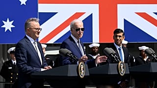 President Joe Biden, center, speaks as Australian Prime Minister Anthony Albanese, left, and British Prime Minister Rishi Sunak listen at Naval Base Point Loma, 13 March 2023