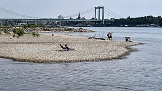 People enjoy the sunny weather on dry river banks of Germany's most important river Rhine in Cologne, Germany, after a long time of drought, 27 April 2020.