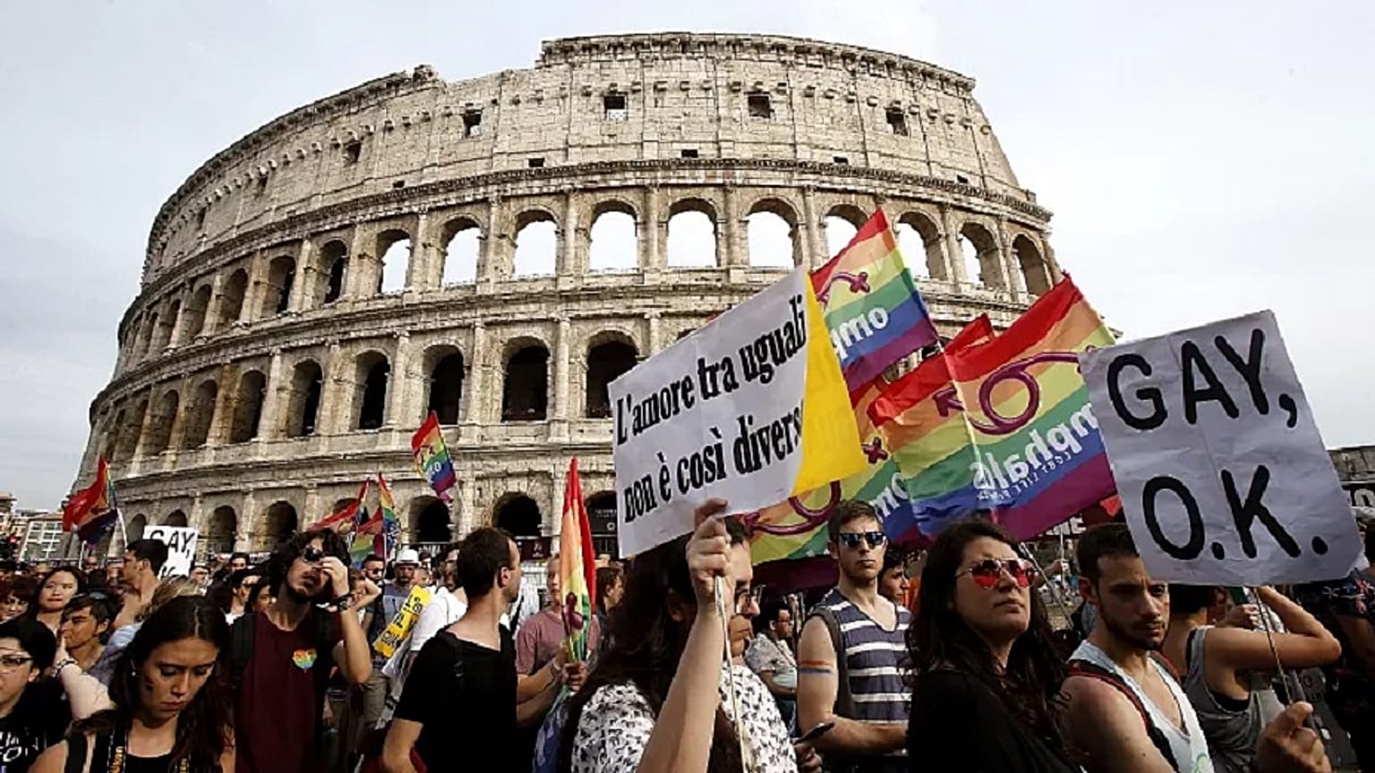 People march past the Colosseum during the Gay Pride parade in Rome, June 11, 2016.  