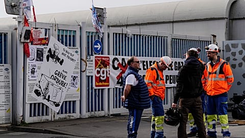 Municipality workers block the entrance of a waste incarnation plant in Paris, Friday, March 17, 2023. 