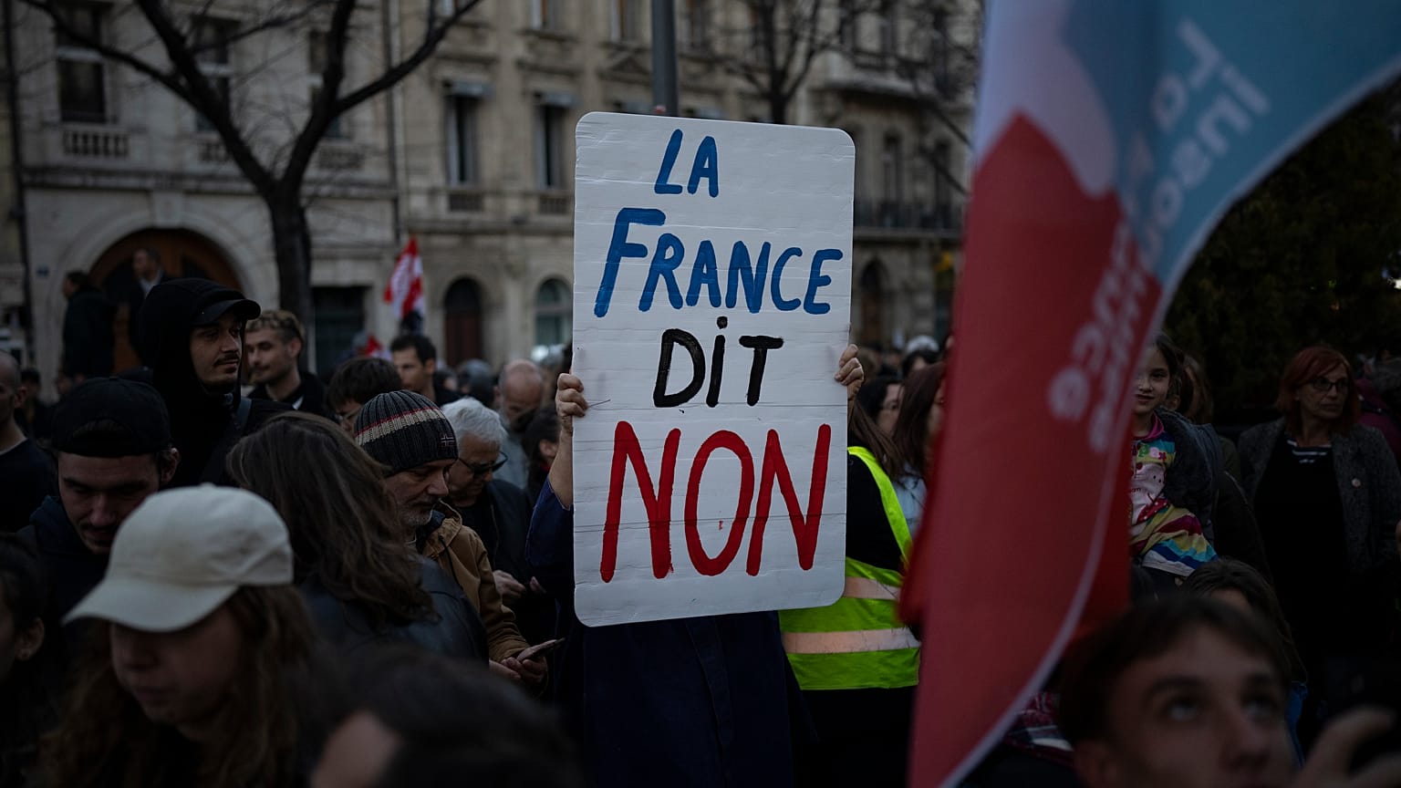 A woman holds a sign reading "France says no" during a demonstration in Marseille. 16 March, 2023