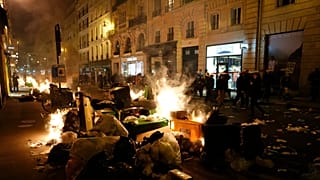 Garbage is set on fire by protesters after a demonstration near Concorde square, in Paris