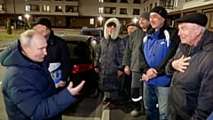 Russian TV Pool on Sunday, March 19, 2023, Russian President Vladimir Putin talks with local residents during his visit to Mariupol