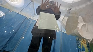 A woman votes during parliamentary elections in Almaty on March 19, 2023.