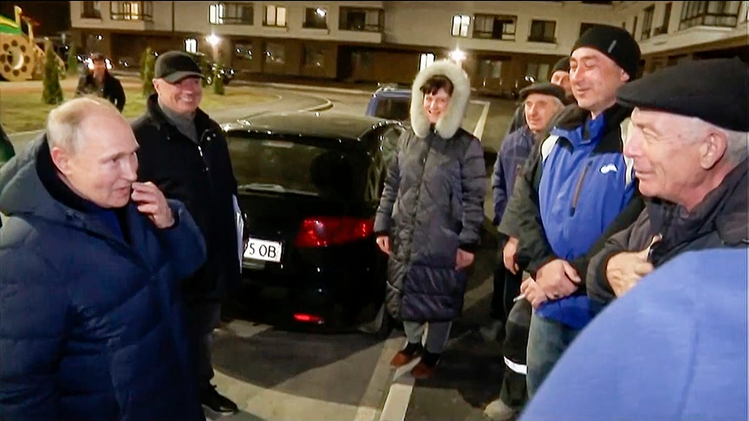 Sunday, March 19, 2023, Russian President Vladimir Putin talks with local residents during his visit to Mariupol.