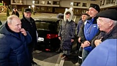 Sunday, March 19, 2023, Russian President Vladimir Putin talks with local residents during his visit to Mariupol.