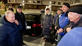 Sunday, March 19, 2023, Russian President Vladimir Putin talks with local residents during his visit to Mariupol.