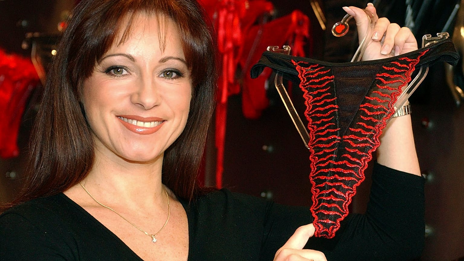 The late Jacqueline Gold holds underwear at one of her Ann Summers stores - FILE