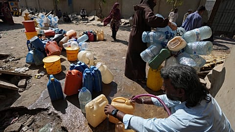 People collecting drinking water in a slum area of Karachi, Pakistan, Tuesday, March 21, 2023. World Water Day will be observed on March 22 
